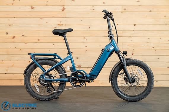 Blue step-through electric bicycle with fat tires and an integrated battery, built for stable, comfortable urban rides