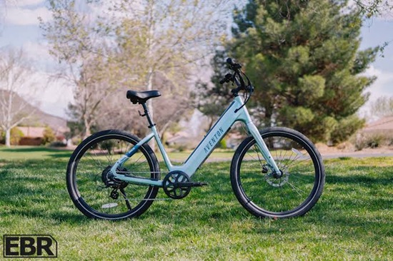 Light blue step-through e-bike with a comfortable upright design, integrated battery, and rear hub motor for smooth everyday riding.