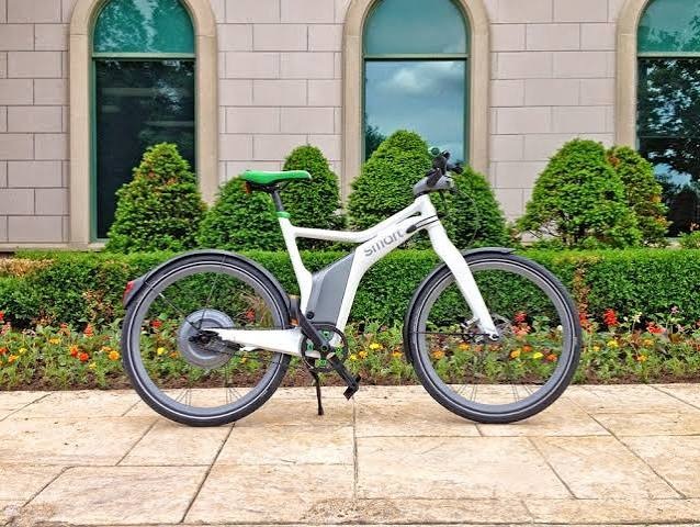 Sleek white smart e-bike with an integrated battery, hub motor, and aerodynamic frame designed for efficient urban commuting.