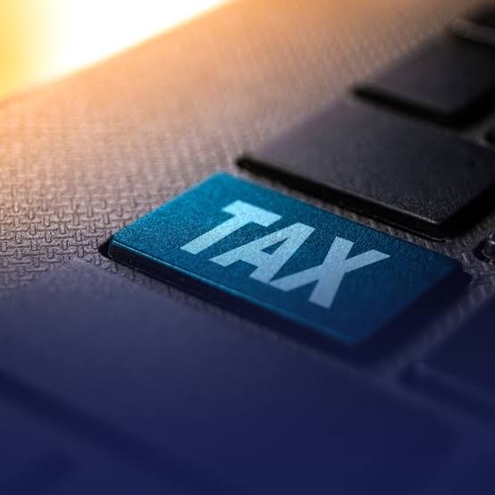 Close-up of a computer keyboard featuring a prominent “TAX” key, symbolizing taxes, tax calculations, and financial obligations.
